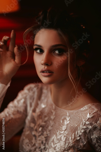 Beautiful bride with a fashionable wedding hairstyle - in an expensive hotel room. Portrait of a young beautiful bride. Wedding.