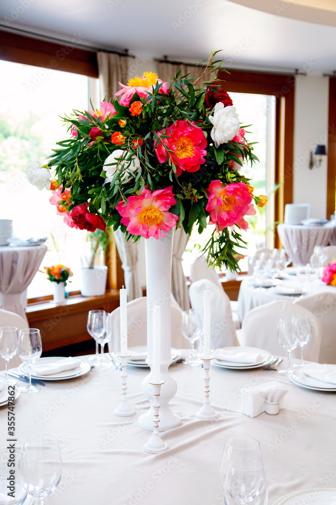 this is a bouquet of peonies in a restaurant on the table this is a bouquet of peonies in a restaurant on the table