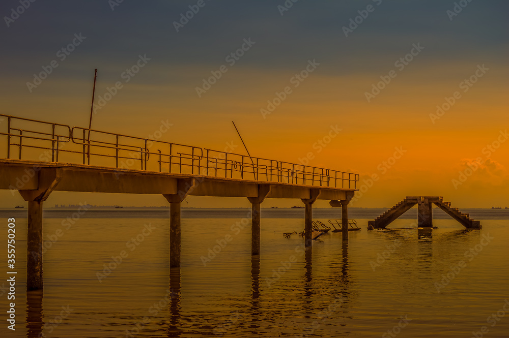 Under construction damaged  bridge and pier at Inhaca or Inyaka Island near Portuguese Island in Maputo Mozambique during sunset