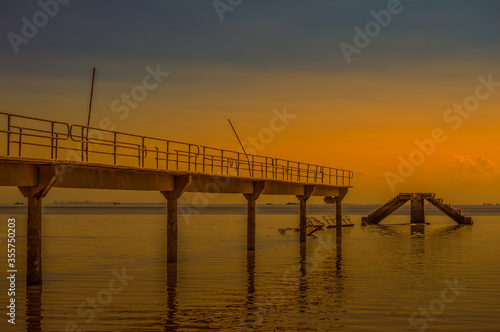 Under construction damaged  bridge and pier at Inhaca or Inyaka Island near Portuguese Island in Maputo Mozambique during sunset