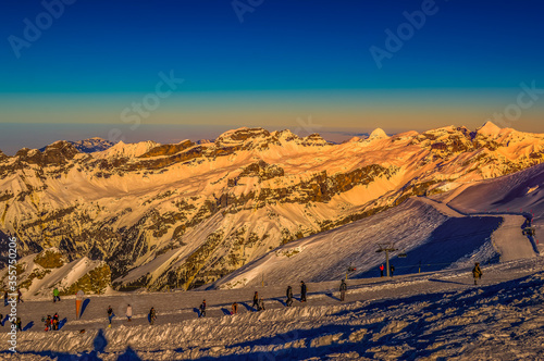 Snow covered Mount Titlis in Swiss Switzerland near Engelberg , people doing snow activities