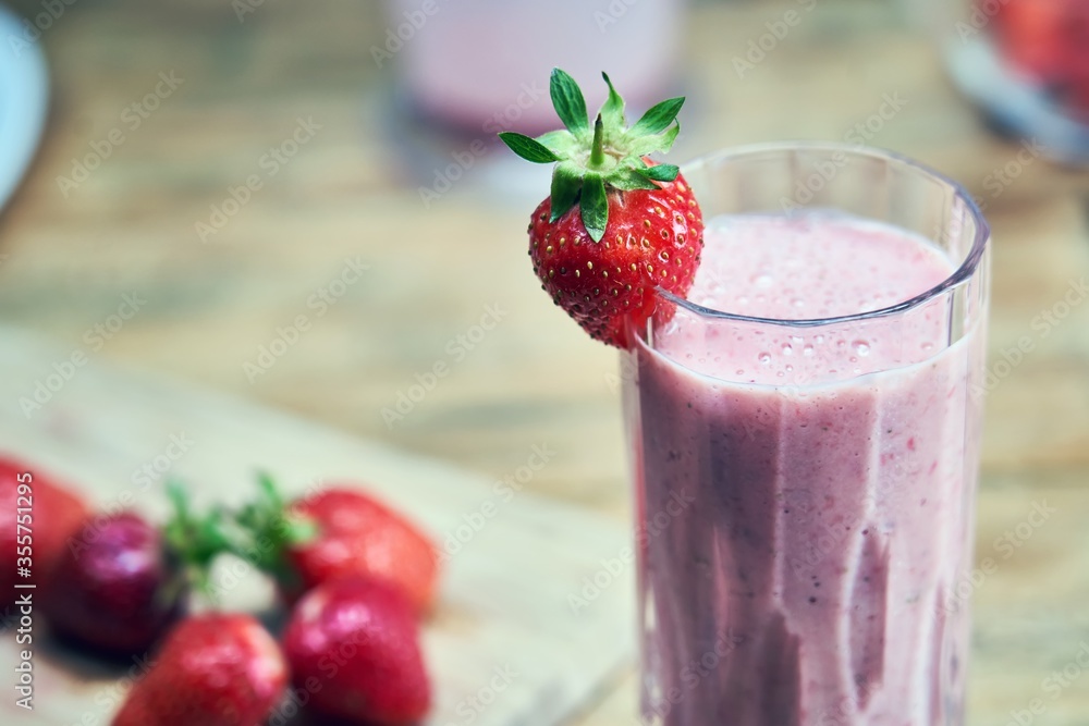 Strawberry shake with strawberries on wooden table. Healthy smoothie and summertime concepts. Strawberry shake with strawberries on wooden table. Healthy smoothie and summertime concepts.