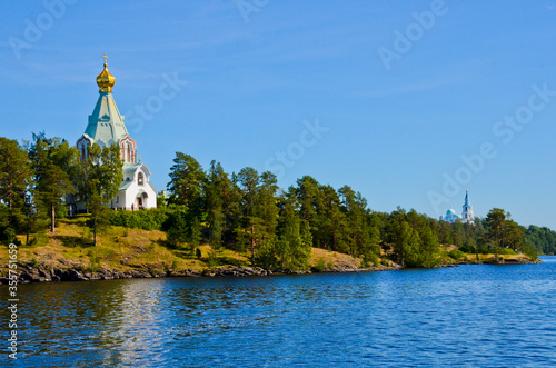 Nikolsky skit on Valaam island as seen from Ladoga lake. Pilgrimage and vacation concept, horizontal photo photo