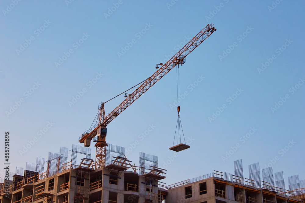 Industrial construction cranes the construction of an building Industrial construction cranes the construction of an building