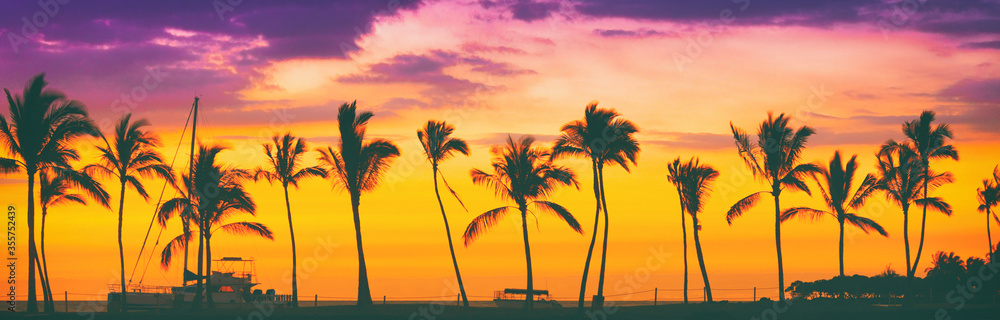Sunset beach palm trees silhouette in sun glow flare panoramic. Hawaii travel destination banner panorama header background