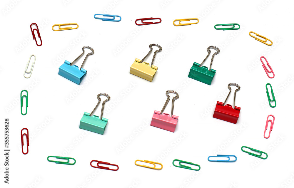 Paper clips and binders on paper Paper clips and binders on paper