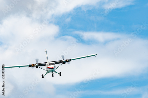 Twin otter DHC-6-300 aircraft with wheels down prepares to land