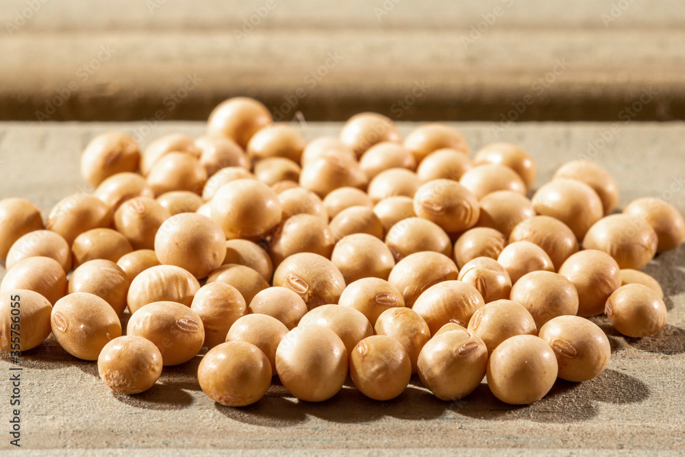 Brazilian soybean seeds background with selective focus on wooden background Brazilian soybean seeds background with selective focus on wooden background