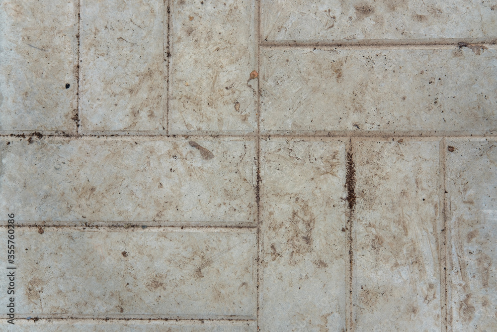 Background from dirty textured tiles with a pattern in the form of horizontal and vertical lines. Dirty concrete background close-up. Background from dirty textured tiles with a pattern in the form of horizontal and vertical lines. Dirty concrete background close-up.