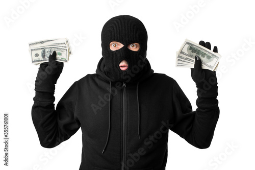 Fotografiet Arrested masked thief with raised arms isolated over white wall