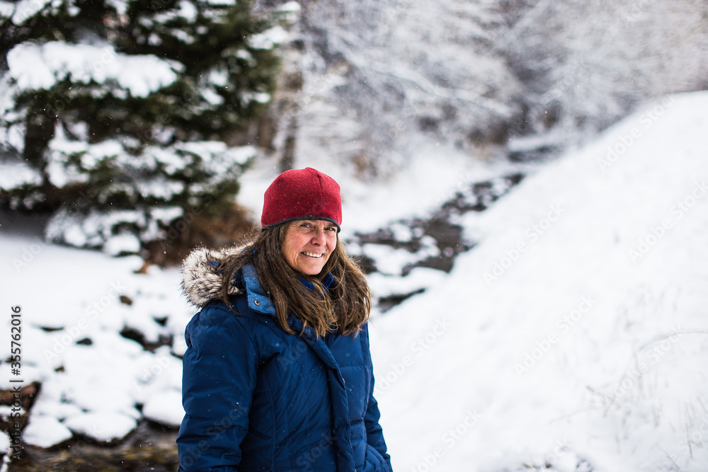 A beautiful woman enjoying a day in a winter forest in Colorado, USA A beautiful woman enjoying a day in a winter forest in Colorado, USA