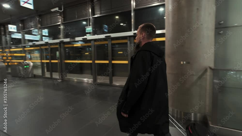 Man with baggage moving up on escalator. Subway underground station Man with baggage moving up on escalator. Subway underground station