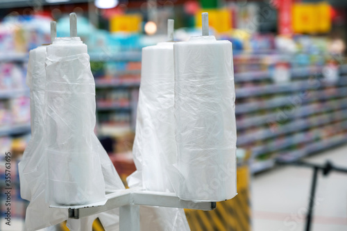 Obraz na płótnie disposable plastic bags for packaging bulk goods and fruits and vegetables. environmental issue with free plastic bags in supermarkets w salonie