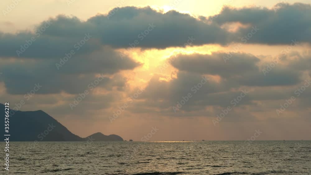Amazing beautiful sunrise over the tropical beach. Orange and Yellow rim light of sun over sea. Beautiful serene scene. Morning. Concept of asian travel, vacation summer and nature background. Amazing beautiful sunrise over the tropical beach. Orange and Yellow rim light of sun over sea. Beautiful serene scene. Morning. Concept of asian travel, vacation summer and nature background.