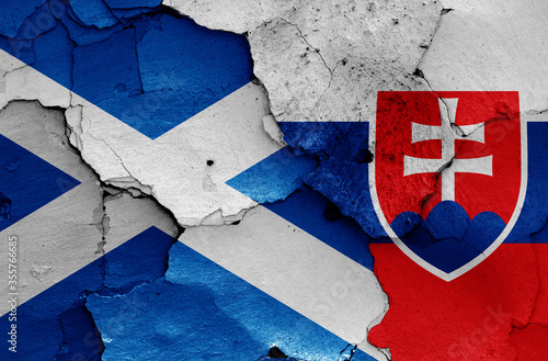 flags of Scotland and Slovakia painted on cracked wall