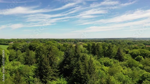 Aerial rising shot over a forest, in the English countryside on bright spring day. photo