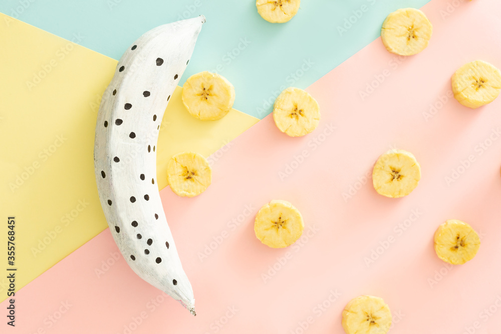 blue, white pink colored banana peels on pink, purple background, inclusion concept art
