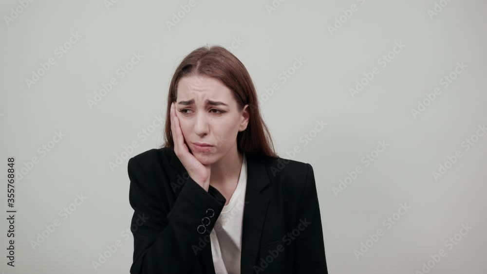 Touching mouth with hand painful expression because of toothache or struggling dental illness teeth. Dentist. Arm on the cheek, rubbing sore place. Feeling pain, suffering from bad state health.