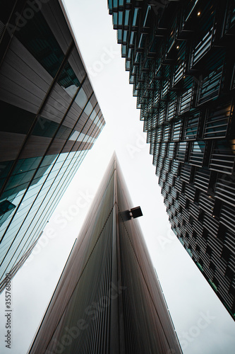 Look up at a modern urban facade of a business district geometrical building