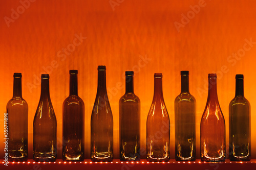 abstract empty wine bottles with orange led illumination