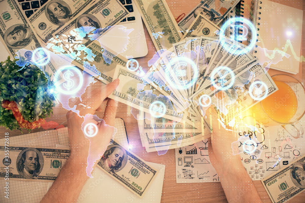 Multi exposure of financial graph drawing hologram and USA dollars bills and man hands. Analysis concept. Multi exposure of financial graph drawing hologram and USA dollars bills and man hands. Analysis concept.