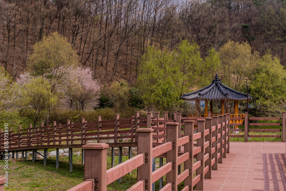 Oriental gazebo behind wooden boardwalk Oriental gazebo behind wooden boardwalk