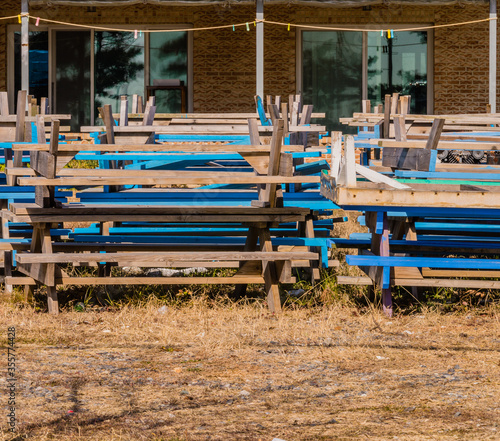 Blue and white wooden picnic table stacks