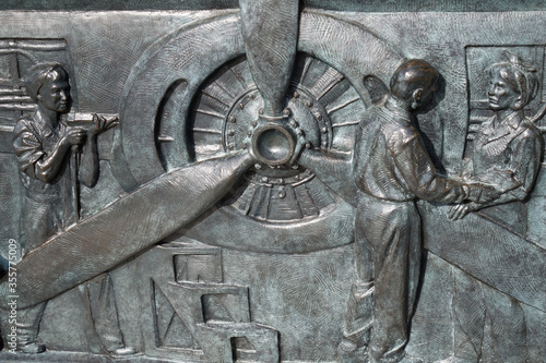 Bronze bas-relief showing women working in the manufacturing of aircrafts, World War II Memorial in Washington, D.C.