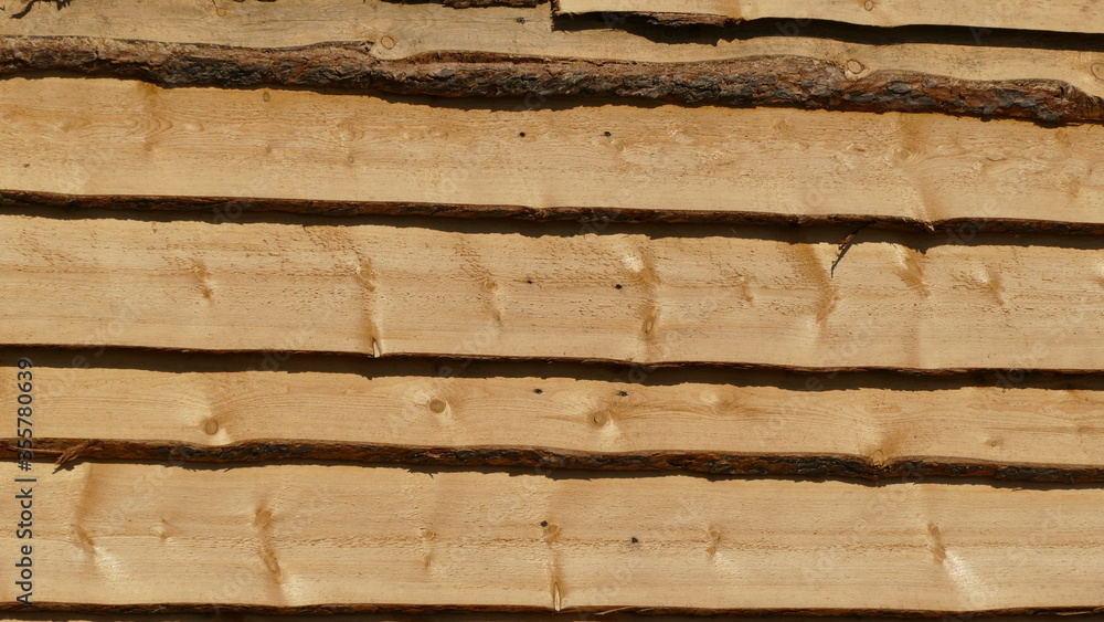 the wall is covered with wooden boards the wall is covered with wooden boards