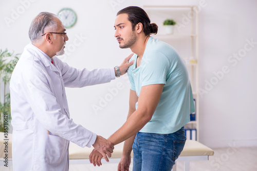 Young back injured man visiting experienced male doctor © Elnur