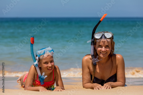 Mom with a daughter in masks for snorkeling