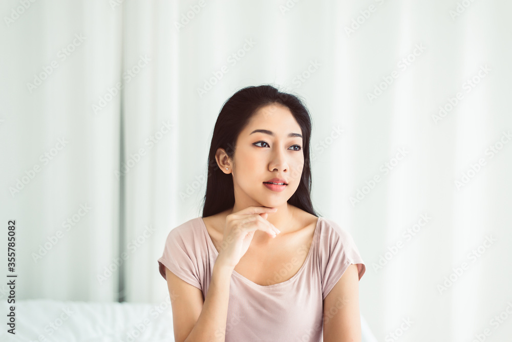 Beautiful young asian woman happy and smiling face while sitting at home Beautiful young asian woman happy and smiling face while sitting at home