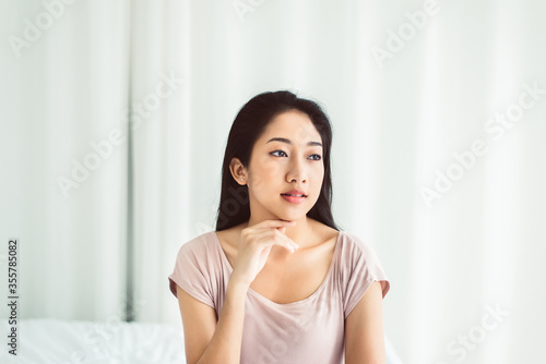Beautiful young asian woman happy and smiling face while sitting at home