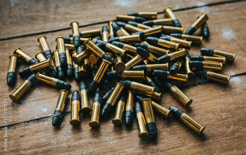 .22 ammunition in pile on a board surrounded by powder photo