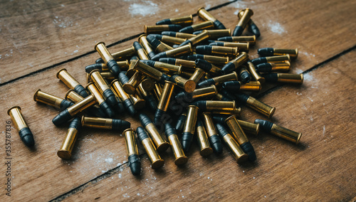 .22 ammunition in pile on a board surrounded by powder photo