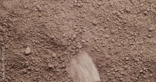 Slowly brushing away to dirt to uncover ancient dinosaur fossil buried in the ground.