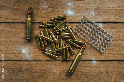 17HMR and .308 Ammunition Flat Lay on board surrounded by powder photo
