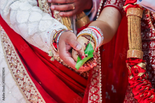 Indian Hindu wedding ceremony and pooja ritual items, hands, and decorations close ups