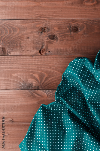 Checkered napkin on wooden background. kitchen textiles