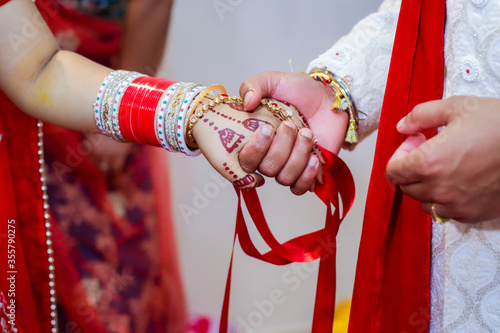 Indian Hindu married couple's holding hands close up