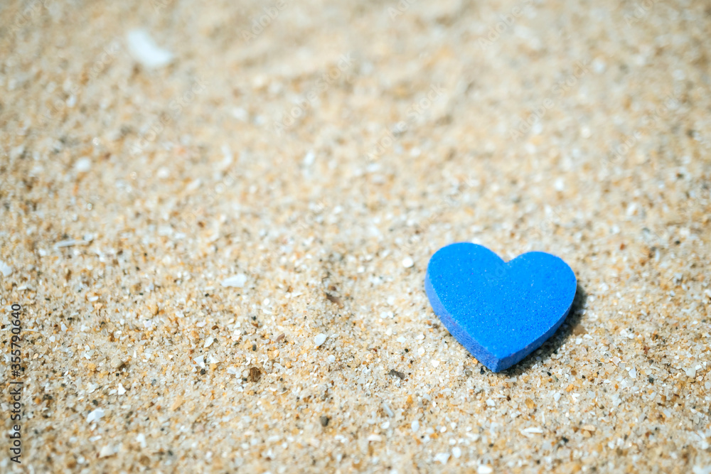 Heart shape on sand at summer beach with copy space. Valentine day concept.