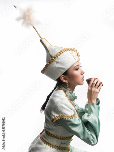 Kazakh musician girl playing on Sazsyrnay in studio on a white background photo