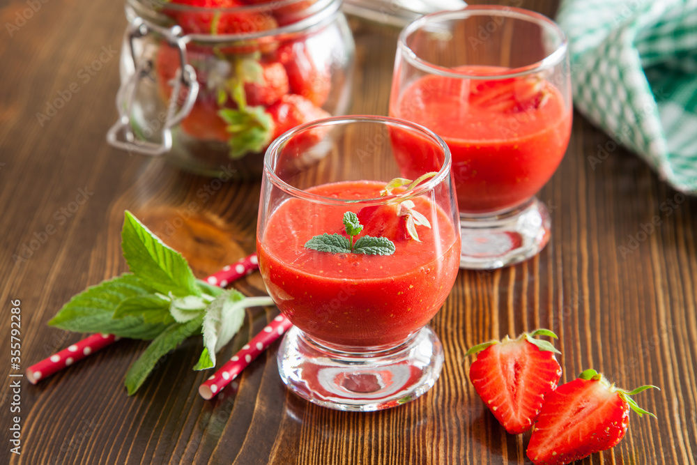 strawberry cocktail in glasses on a tray in a garden, selective focus strawberry cocktail in glasses on a tray in a garden, selective focus