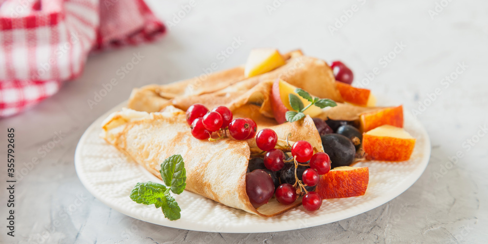 pancakes with berries in a plate on a table, selective focus pancakes with berries in a plate on a table, selective focus