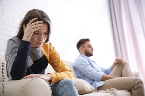 Fotografie Unhappy couple with problems in relationship at home, focus on woman