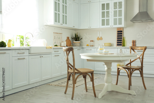 Elegant kitchen interior design with white round table © New Africa