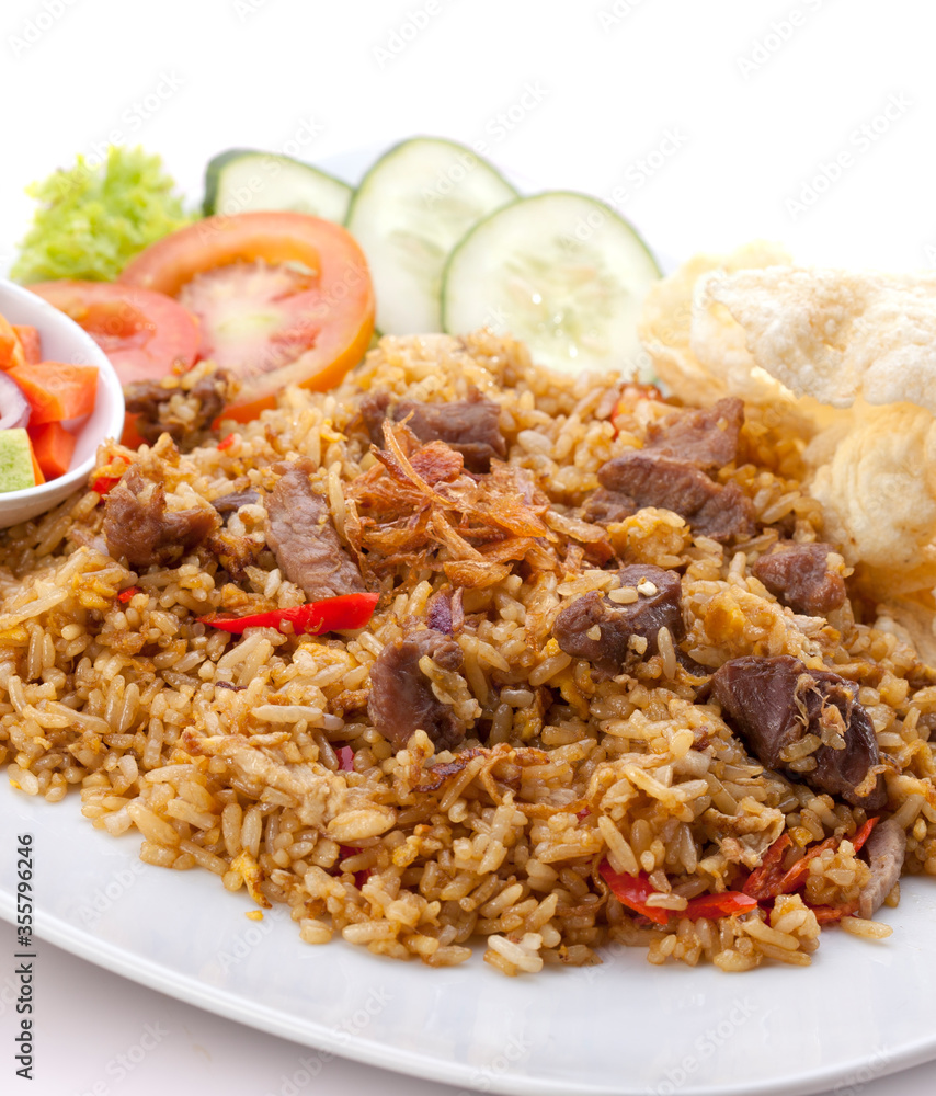 Fried rice. Meat fried rice. Beef fried rice. Lamb fried rice. Fried rice with soy sauce and seasonings, meat, decorated with pickles, tomatoes, cucumbers, chips. Fried rice. Meat fried rice. Beef fried rice. Lamb fried rice. Fried rice with soy sauce and seasonings, meat, decorated with pickles, tomatoes, cucumbers, chips.