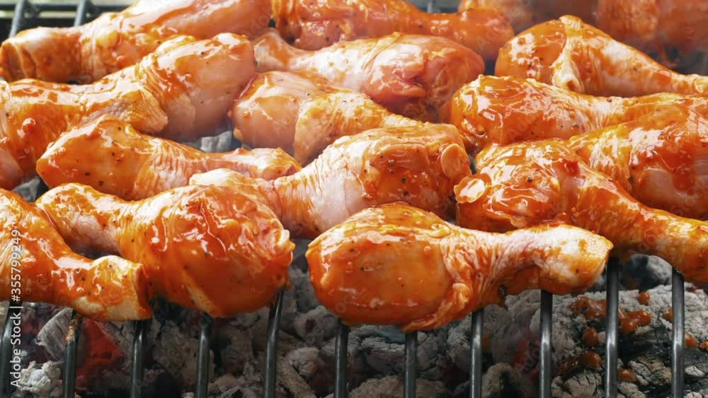 Closeup graded shot of the chicken drumsticks roasting on the charcoal barbecue grill, taken with a macro lens in UHD Closeup graded shot of the chicken drumsticks roasting on the charcoal barbecue grill, taken with a macro lens in UHD
