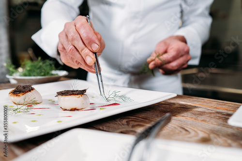 Preparing food in restaurant kitchen