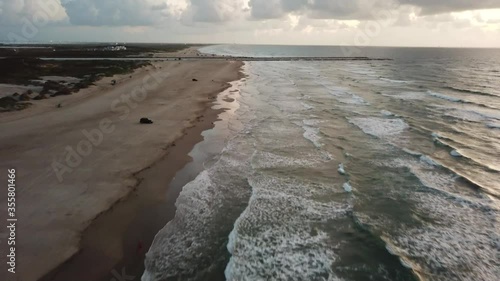Aerial view above the beach and surf at sunrise over Padre Island, Corpus Christi Texas